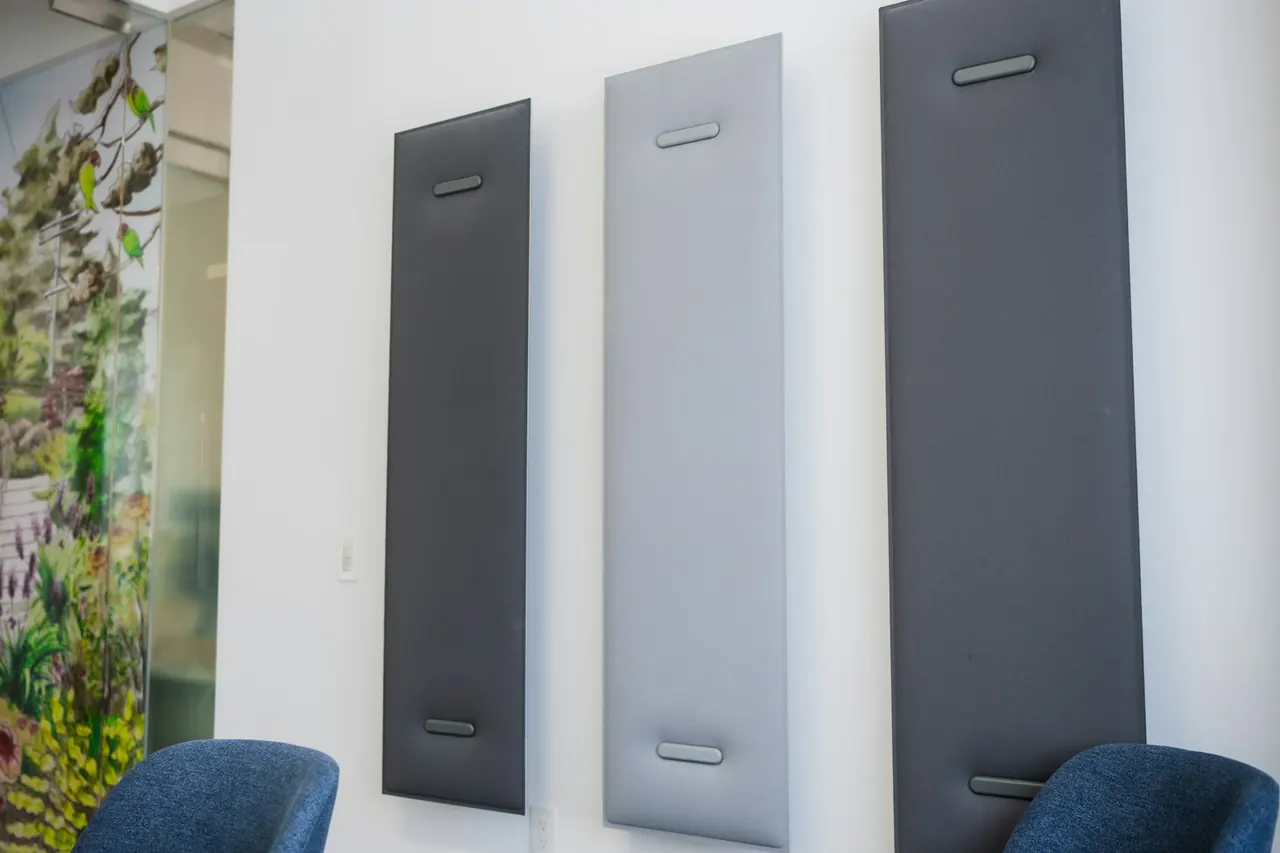 Fabric acoustic panels fixed to a meeting room wall