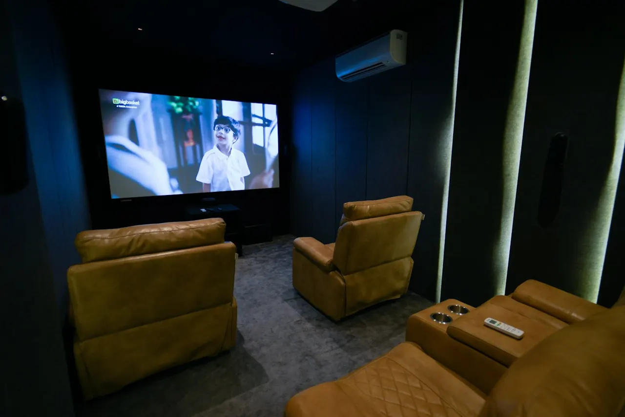 Home theatre with recliner seats facing a projected picture